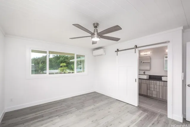 a view of a kitchen with a sink a ceiling fan and wooden floor