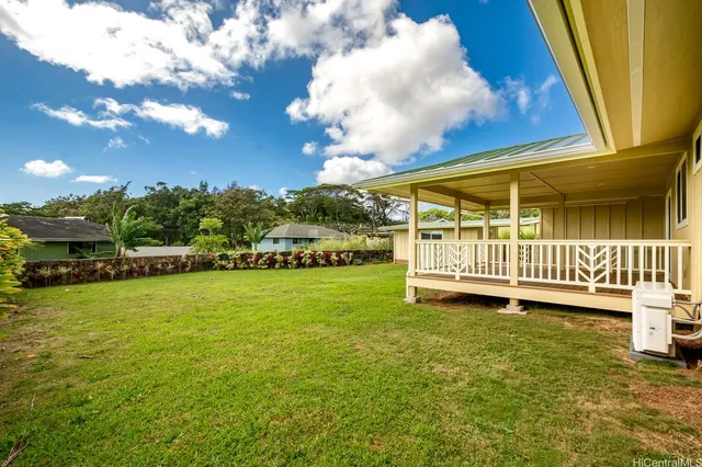 a view of a house with a yard porch and sitting area