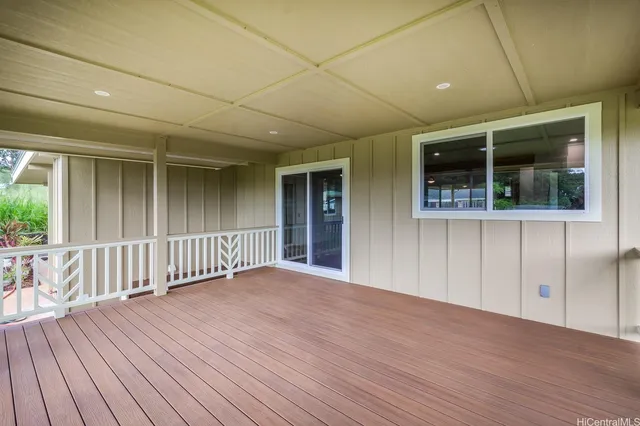 a view of a porch with wooden floor and fence