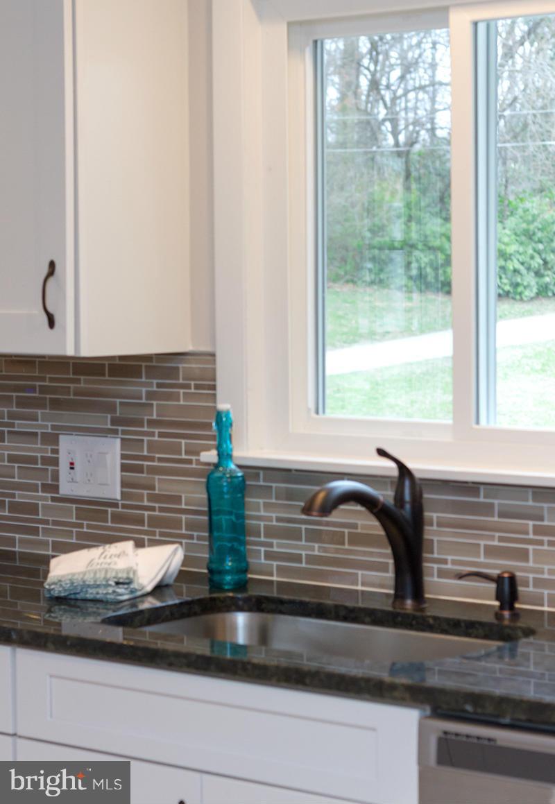 3810 Sweet Air Road Phoenix, MD 21131 - Photo 17 of 30 a kitchen with a sink and wooden cabinets