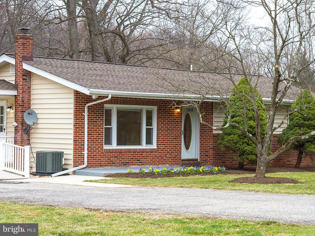 3810 Sweet Air Road Phoenix, MD 21131 - Photo 4 of 30 a front view of a house with a garden and trees