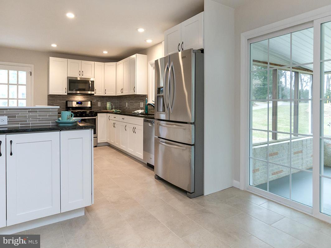 3810 Sweet Air Road Phoenix, MD 21131 - Photo 7 of 30 a kitchen with stainless steel appliances granite countertop a refrigerator and a stove top oven
