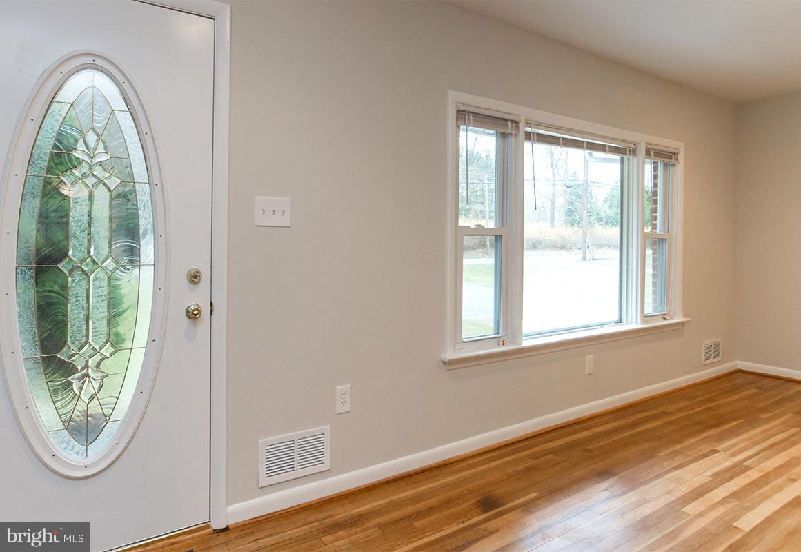 3810 Sweet Air Road Phoenix, MD 21131 - Photo 8 of 30 an empty room with wooden floor windows and outdoor view