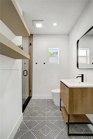 a bathroom with a sink a toilet and mirror