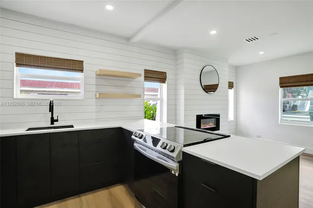 a kitchen with a sink and a fireplace