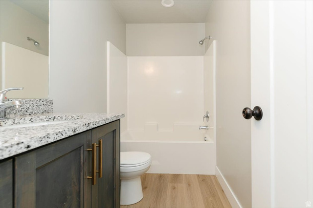 226 South 600 West Logan, UT 84321 - Photo 16 of 25 Full bathroom featuring vanity, light wood-type flooring, and shower / tub combination