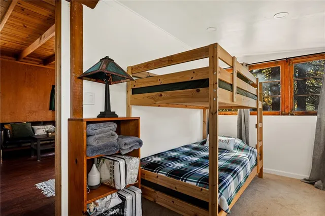a bedroom with a bed and the view of living room