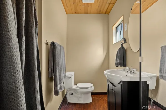 a bathroom with a toilet sink and a mirror