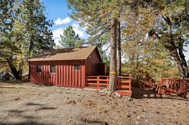a front view of a house with a yard covered in snow