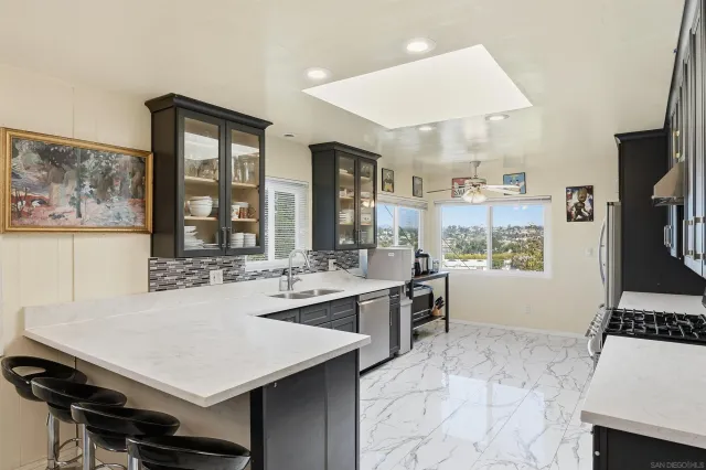 a kitchen with a stove a sink dishwasher and a refrigerator with wooden floor