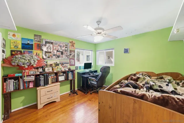 a bedroom with a bed a desk and chair