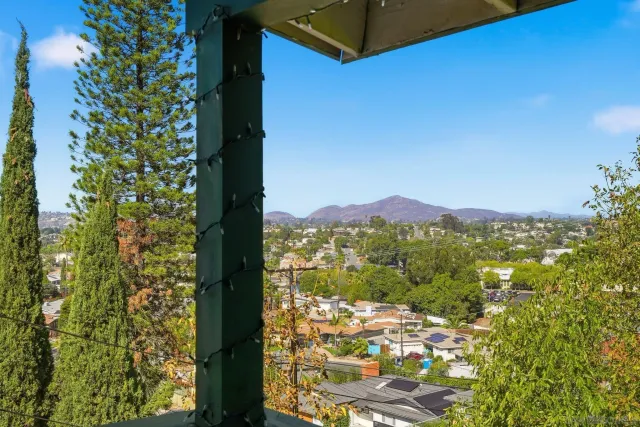 a outdoor space with patio couches and a dining table and chairs with wooden floor