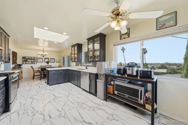 a large kitchen with stainless steel appliances lots of counter space and a sink