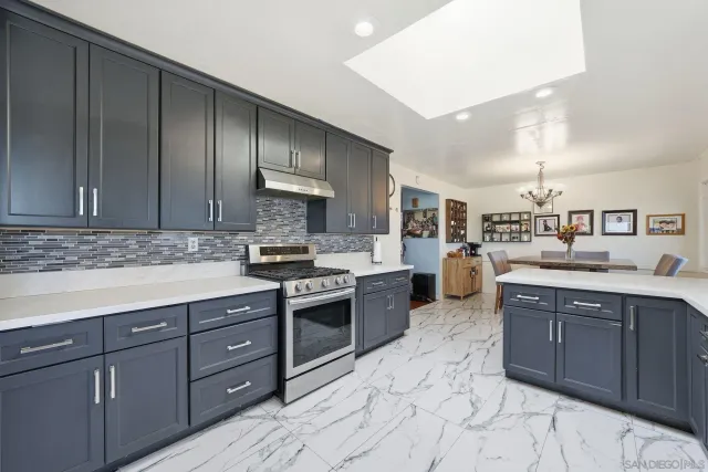 a dining room with furniture and a large window