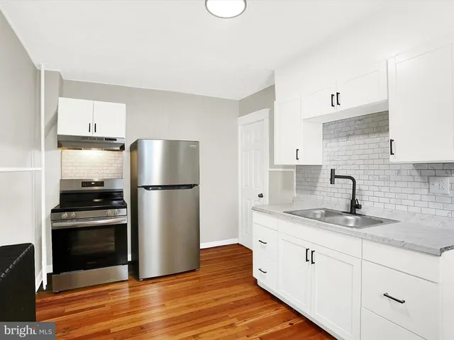 a kitchen with stainless steel appliances granite countertop a refrigerator sink and stove