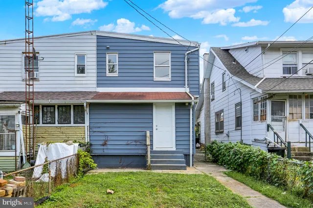 a view of a house with brick walls and a yard