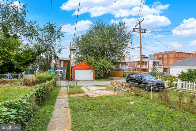 a view of a house with a yard and sitting area