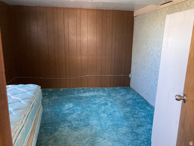 200 South 2800th Street West Ogden, UT 84404 - Photo 16 of 42 Unfurnished bedroom with carpet and wooden walls