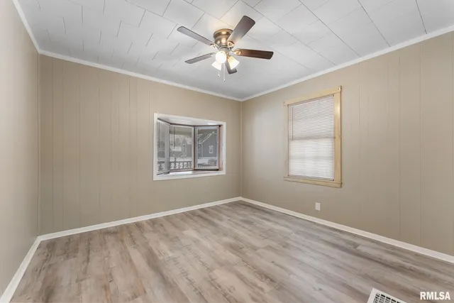 wooden floor in an empty room with a window