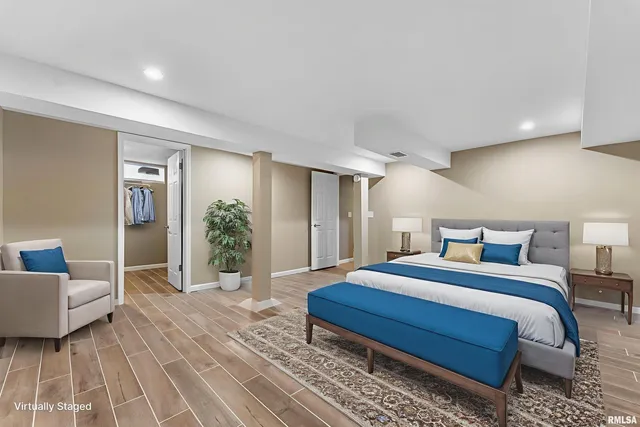 a bedroom with a bed table and a couch