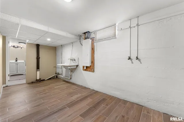 a view of a room with wooden floor and white walls
