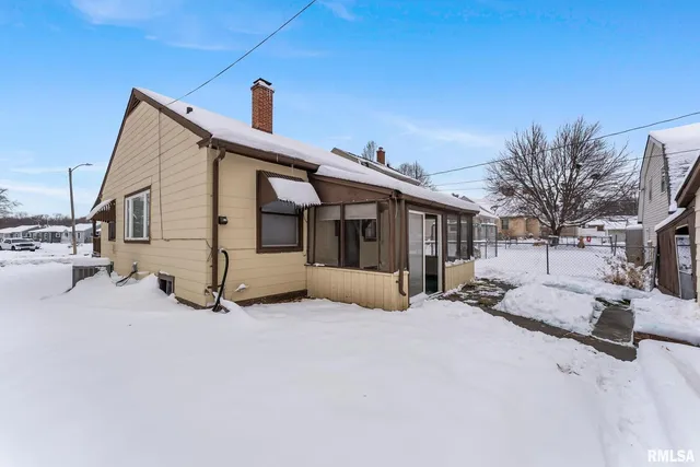 a view of a house with a snow in the yard