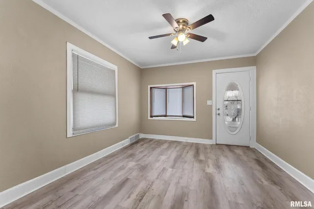 wooden floor in an empty room with a window