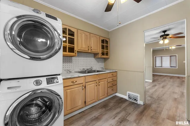 a view of a kitchen with sink washer and dryer