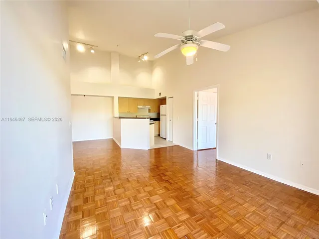 a view of a kitchen with a sink and a refrigerator