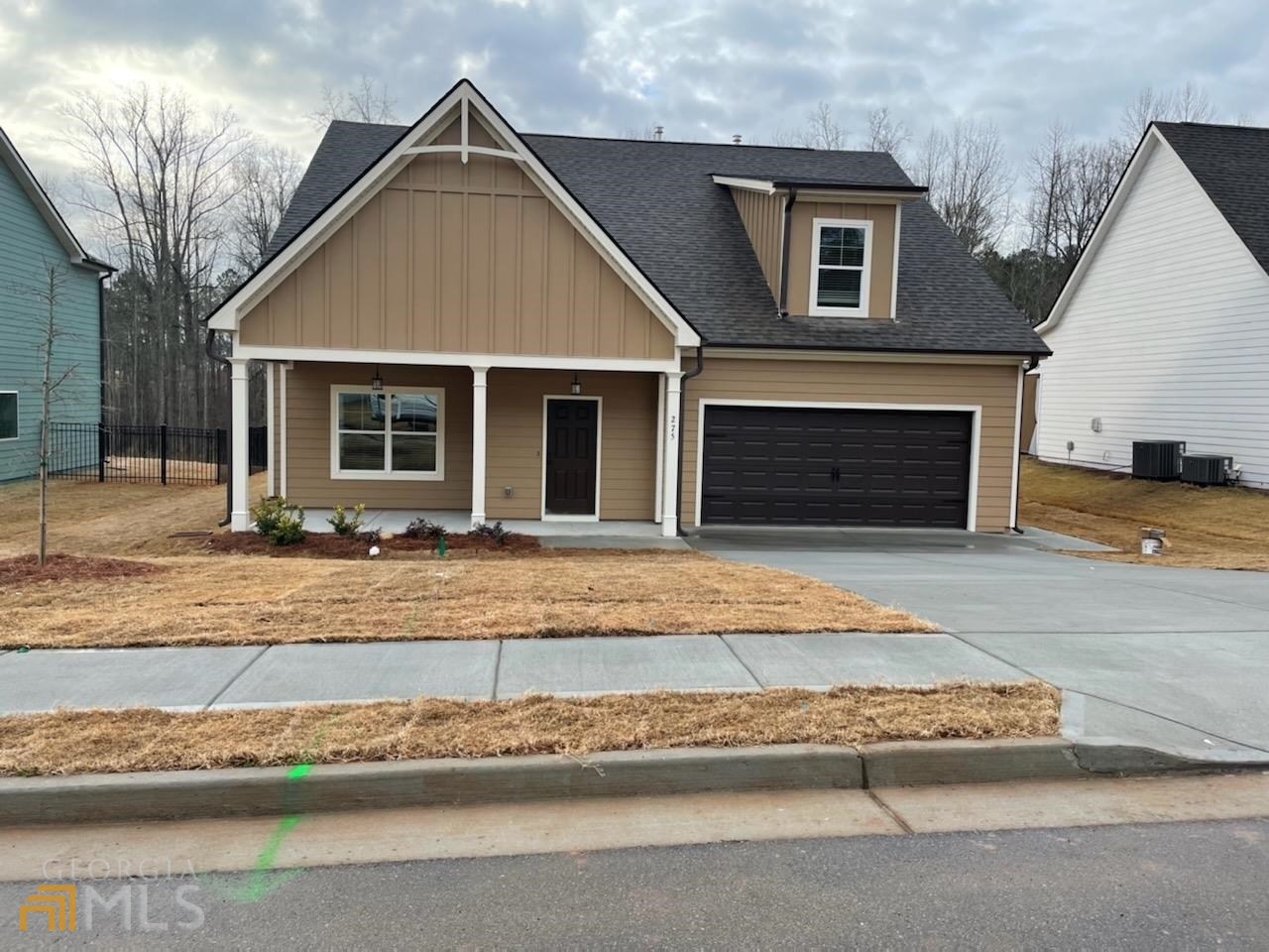 275 S Ridge, Unit 36 Senoia, GA 30276 - Photo 1 of 1 a front view of a house with a yard and garage