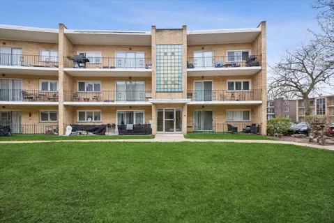 a front view of an apartment with a garden and entertaining space
