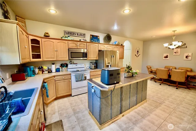 a kitchen with stainless steel appliances granite countertop a sink and cabinets