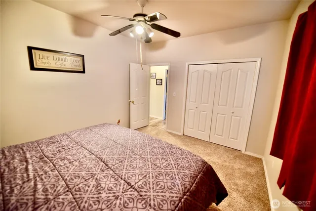 a bedroom with a large bed and a chandelier