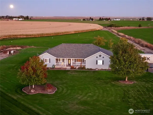 a aerial view of a house with a yard and lake view