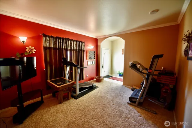 a room with gym equipment and windows