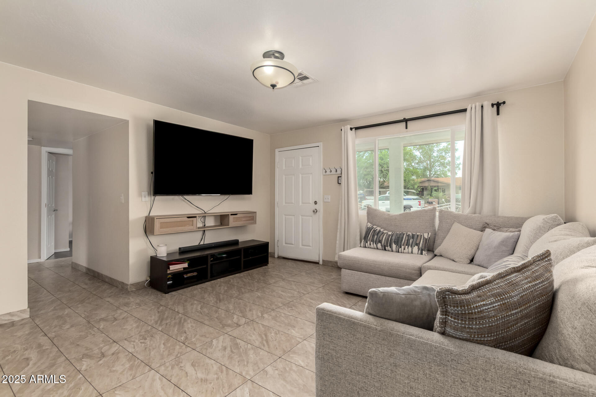 2024 West Roeser Road Phoenix, AZ 85041 - Photo 12 of 36 a living room with furniture and a flat screen tv