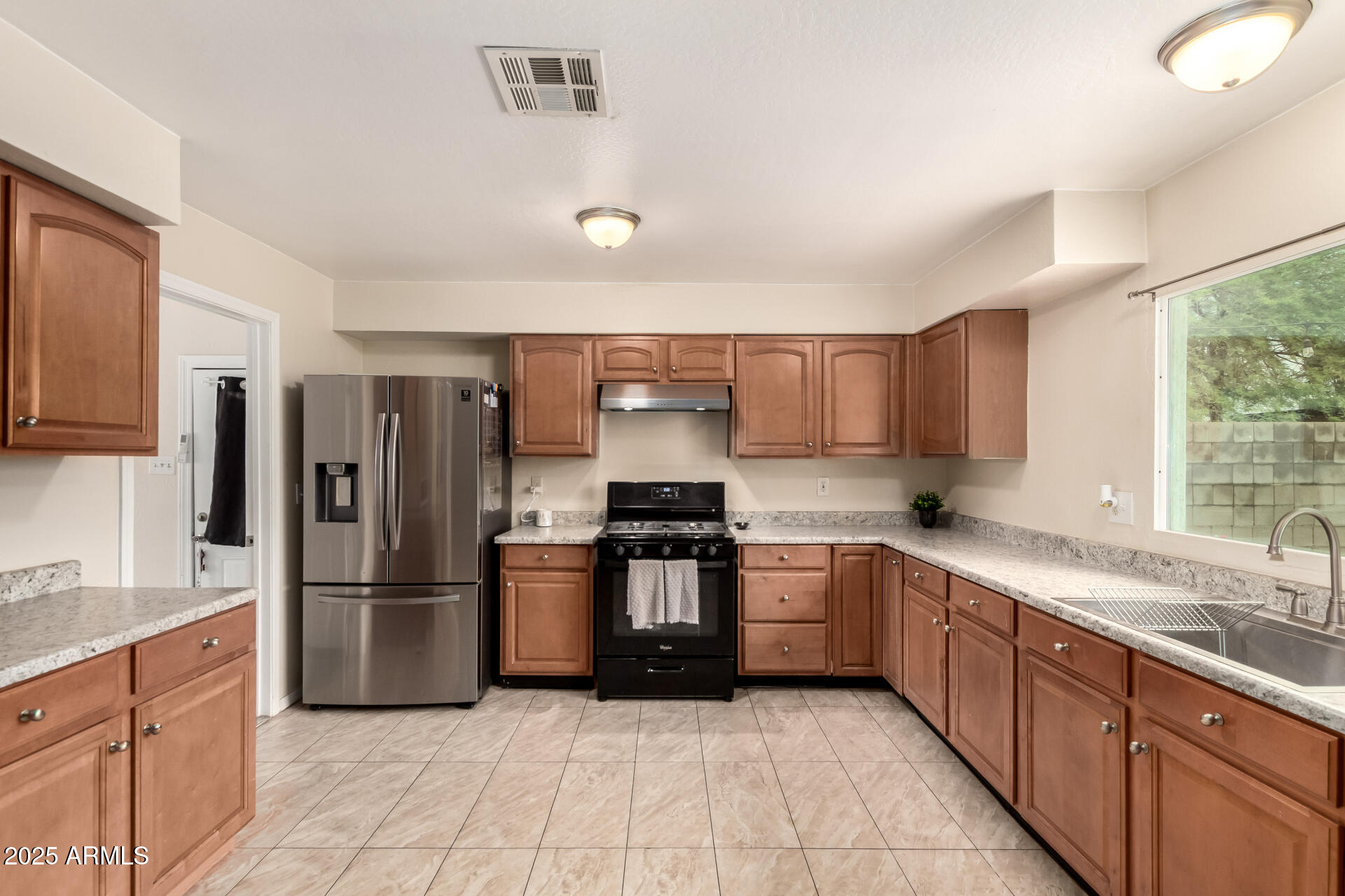 2024 West Roeser Road Phoenix, AZ 85041 - Photo 16 of 36 a kitchen with stainless steel appliances granite countertop a refrigerator sink and stove