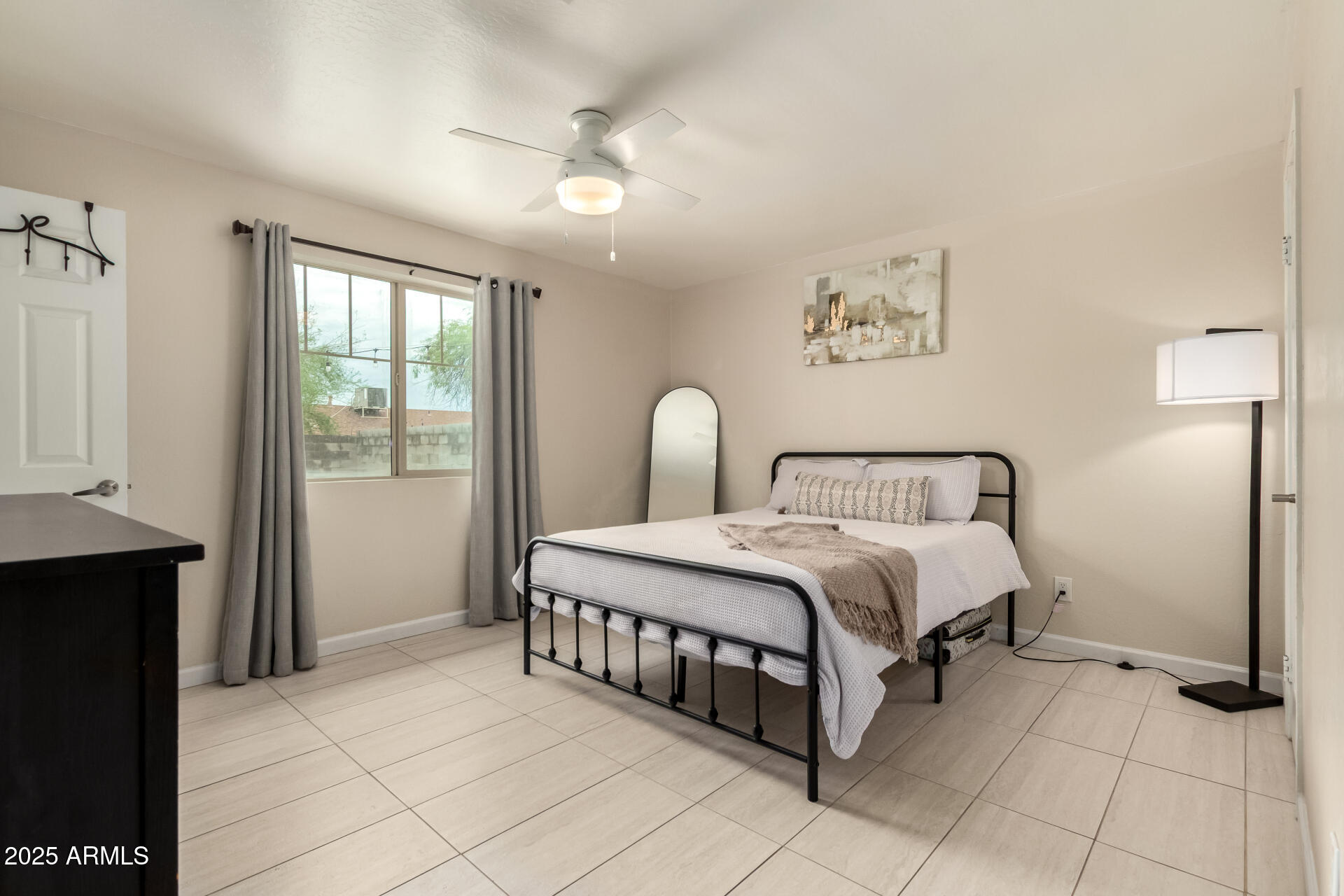 2024 West Roeser Road Phoenix, AZ 85041 - Photo 19 of 36 a spacious bedroom with a bed and a window