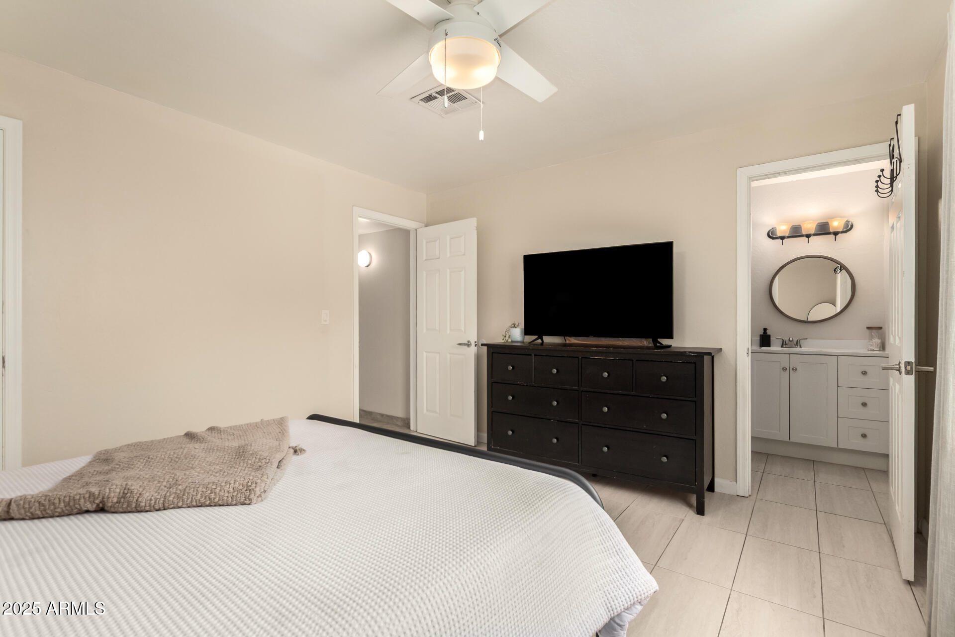 2024 West Roeser Road Phoenix, AZ 85041 - Photo 20 of 36 a bedroom with a bed and a flat screen tv