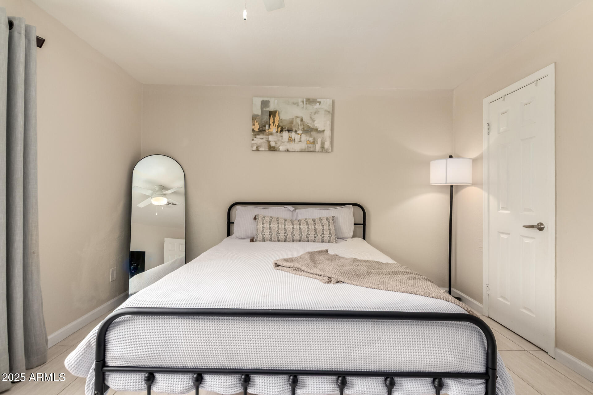 2024 West Roeser Road Phoenix, AZ 85041 - Photo 21 of 36 a bedroom with a bed and a lamp