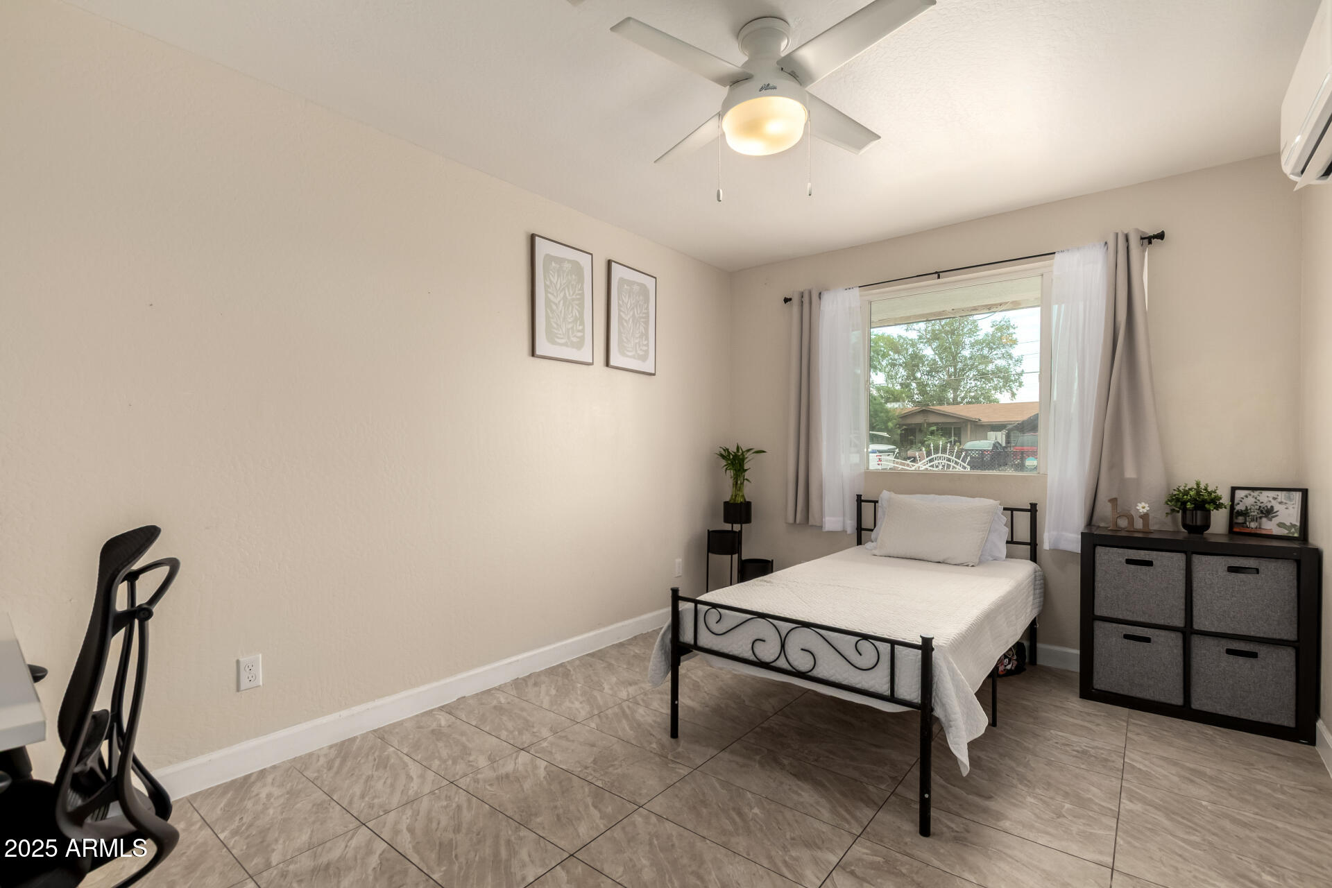 2024 West Roeser Road Phoenix, AZ 85041 - Photo 27 of 36 a bedroom with a bed and a chandelier