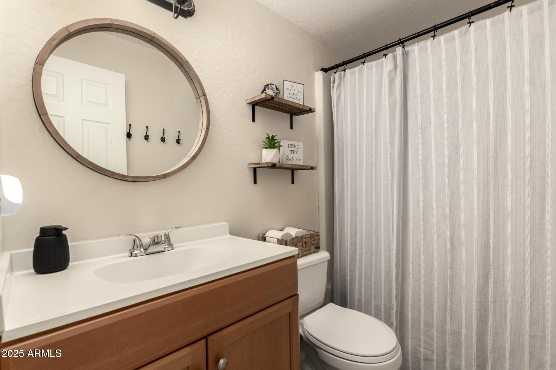 2024 West Roeser Road Phoenix, AZ 85041 - Photo 29 of 36 a bathroom with a sink a toilet and a mirror