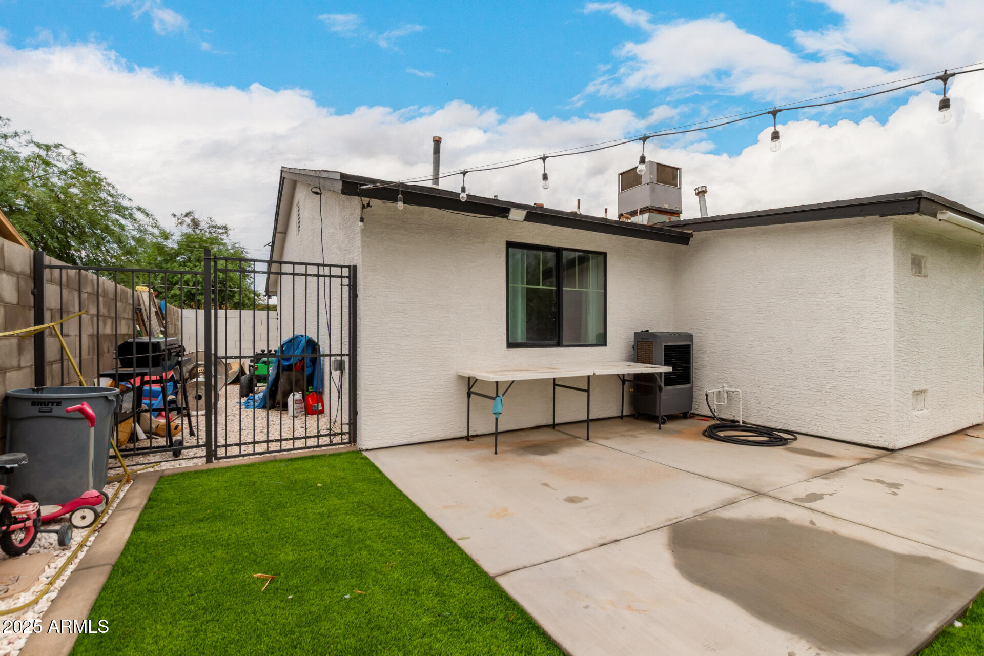 2024 West Roeser Road Phoenix, AZ 85041 - Photo 36 of 36 a view of a patio with dining table and chairs with wooden fence