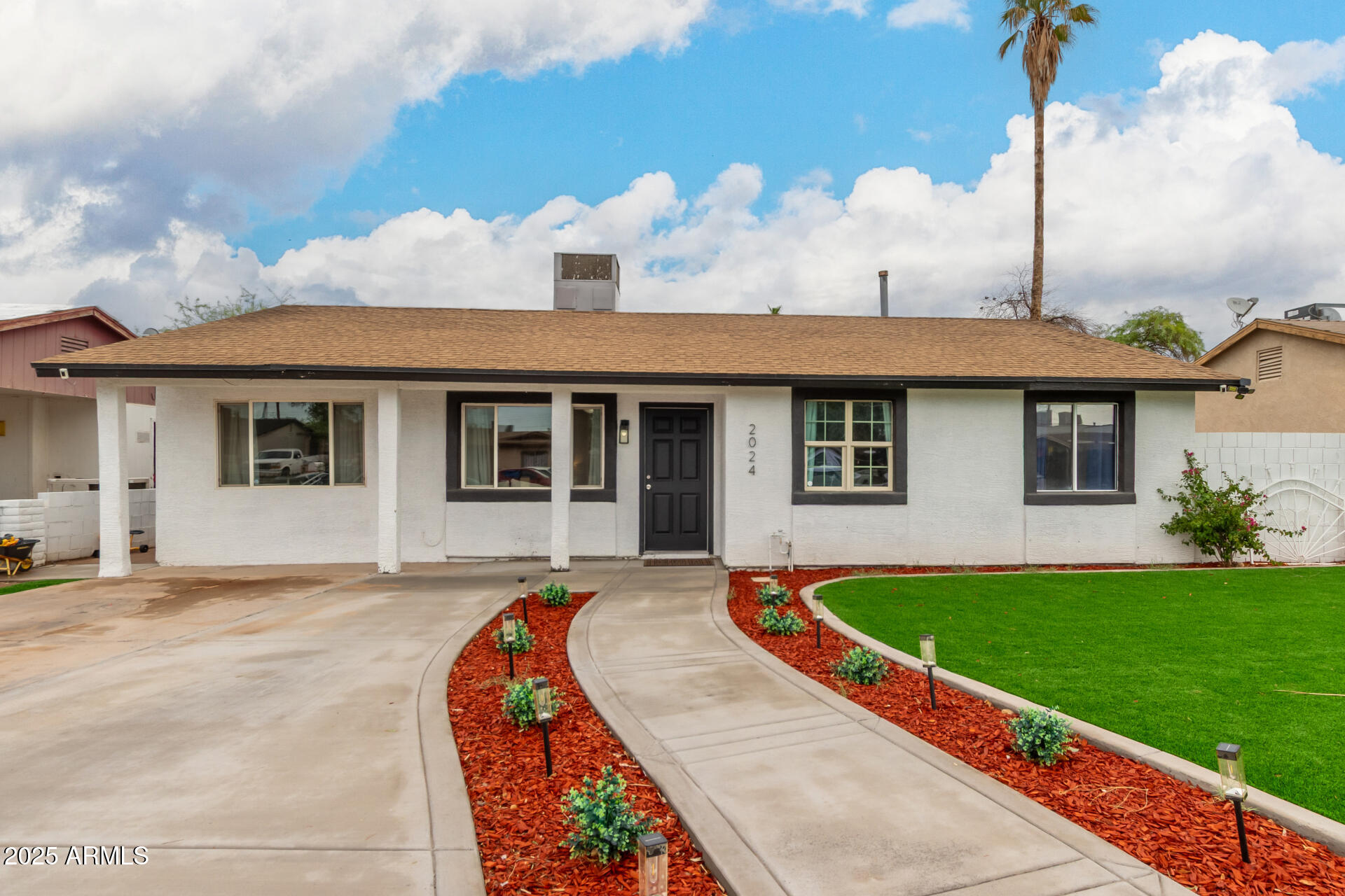 2024 West Roeser Road Phoenix, AZ 85041 - Photo 6 of 36 a front view of a house with a garden