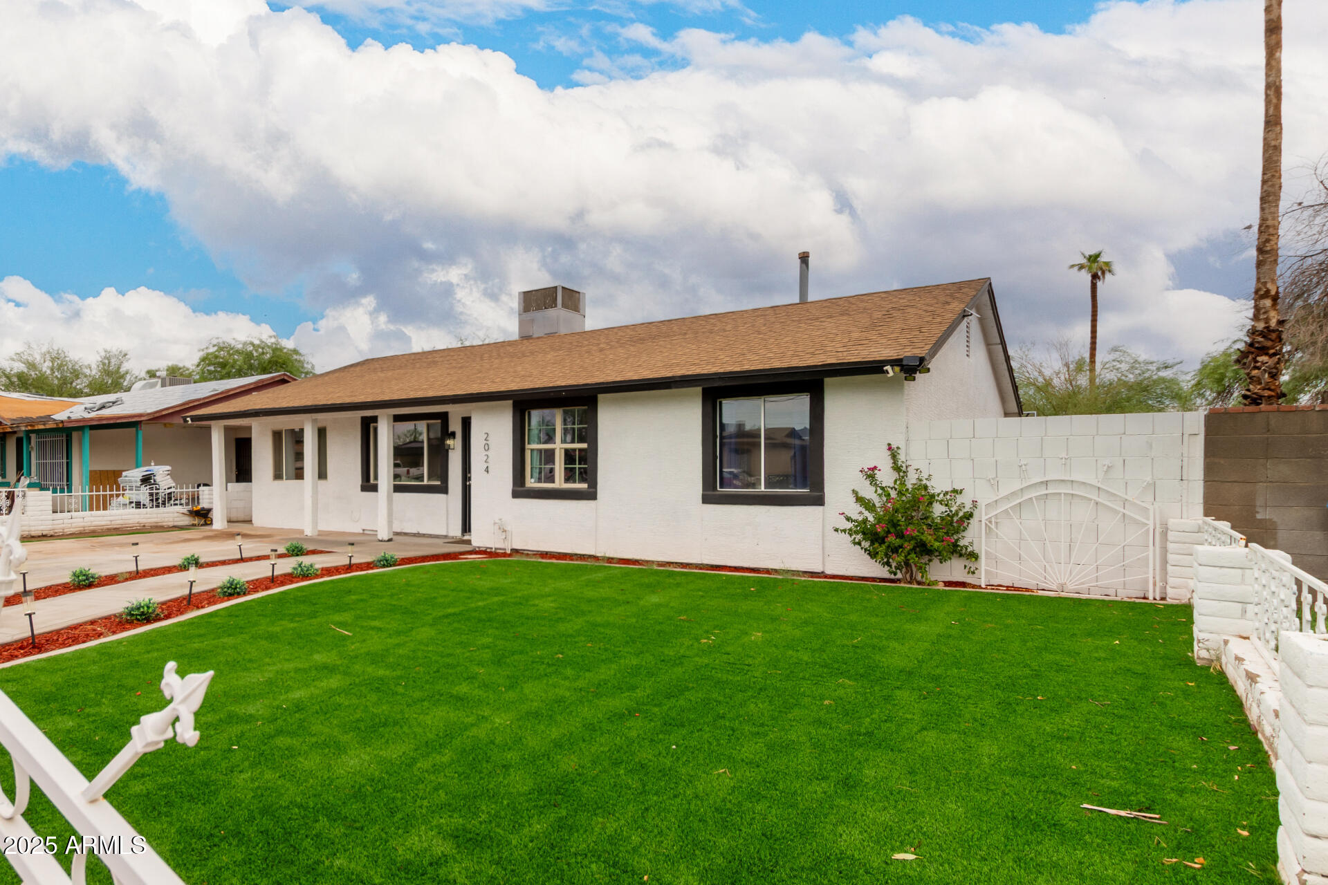 2024 West Roeser Road Phoenix, AZ 85041 - Photo 8 of 36 a front view of a house with a garden and plants