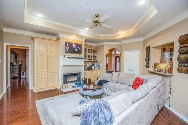 a living room with fireplace furniture and a wooden floor
