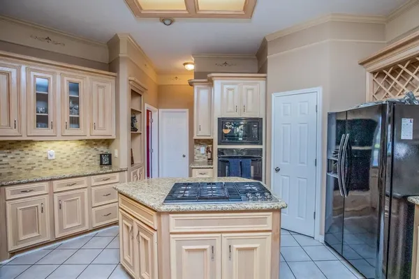a kitchen with stainless steel appliances granite countertop a stove and a refrigerator