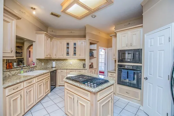 a kitchen with cabinets and stainless steel appliances