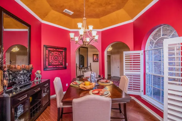 a dining room with furniture and wooden floor
