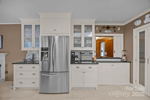 a view of a dining room with furniture a chandelier and a window